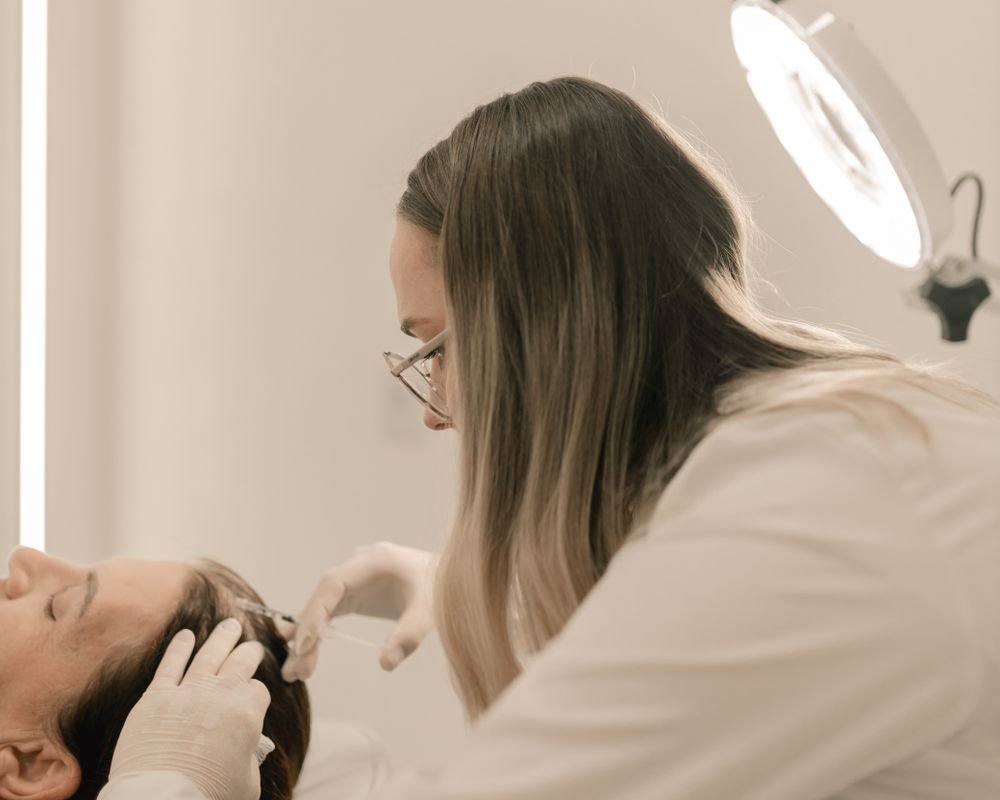 CFH doctor examining a patient's scalp and hair during a consultation